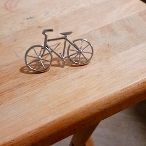 Silver tone brooch in the shape of a bicycle